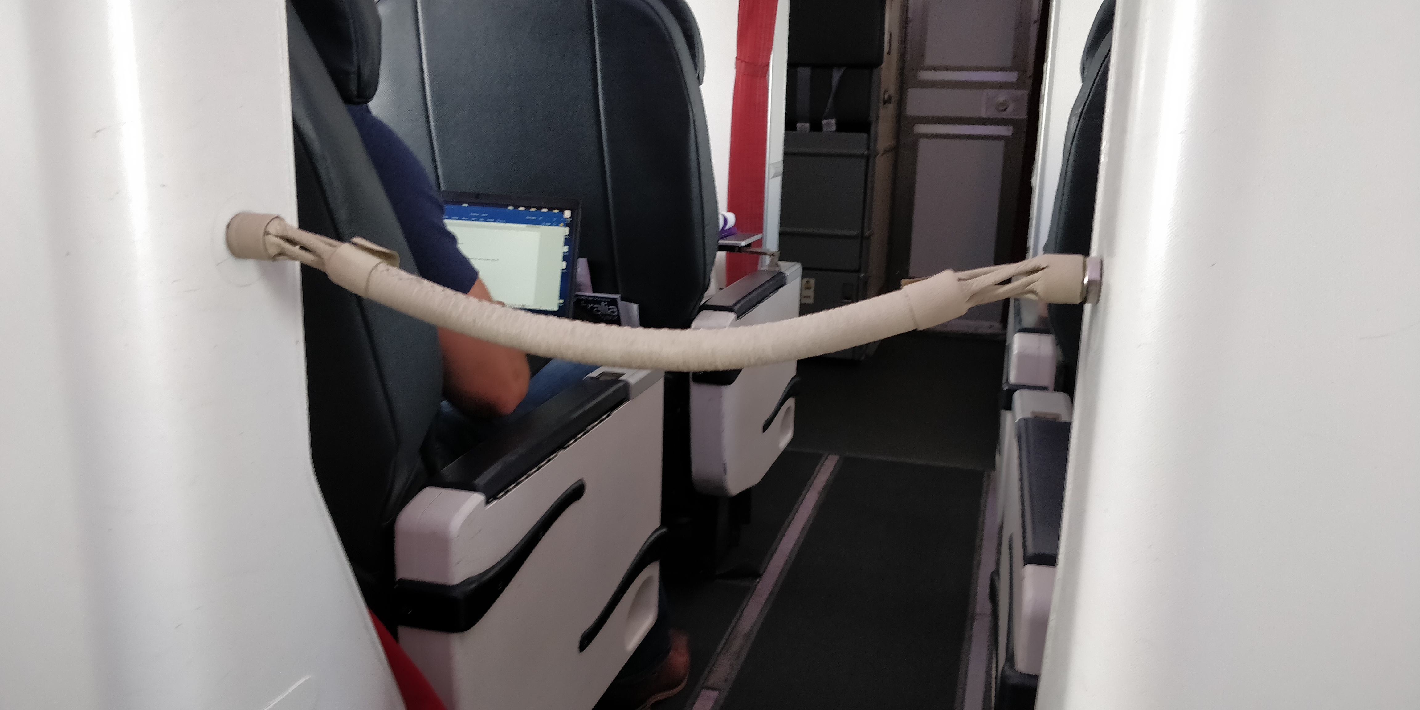 A PICTURE OF VIRGIN 737 BUSINESS CLASS ROPE SEPARATOR