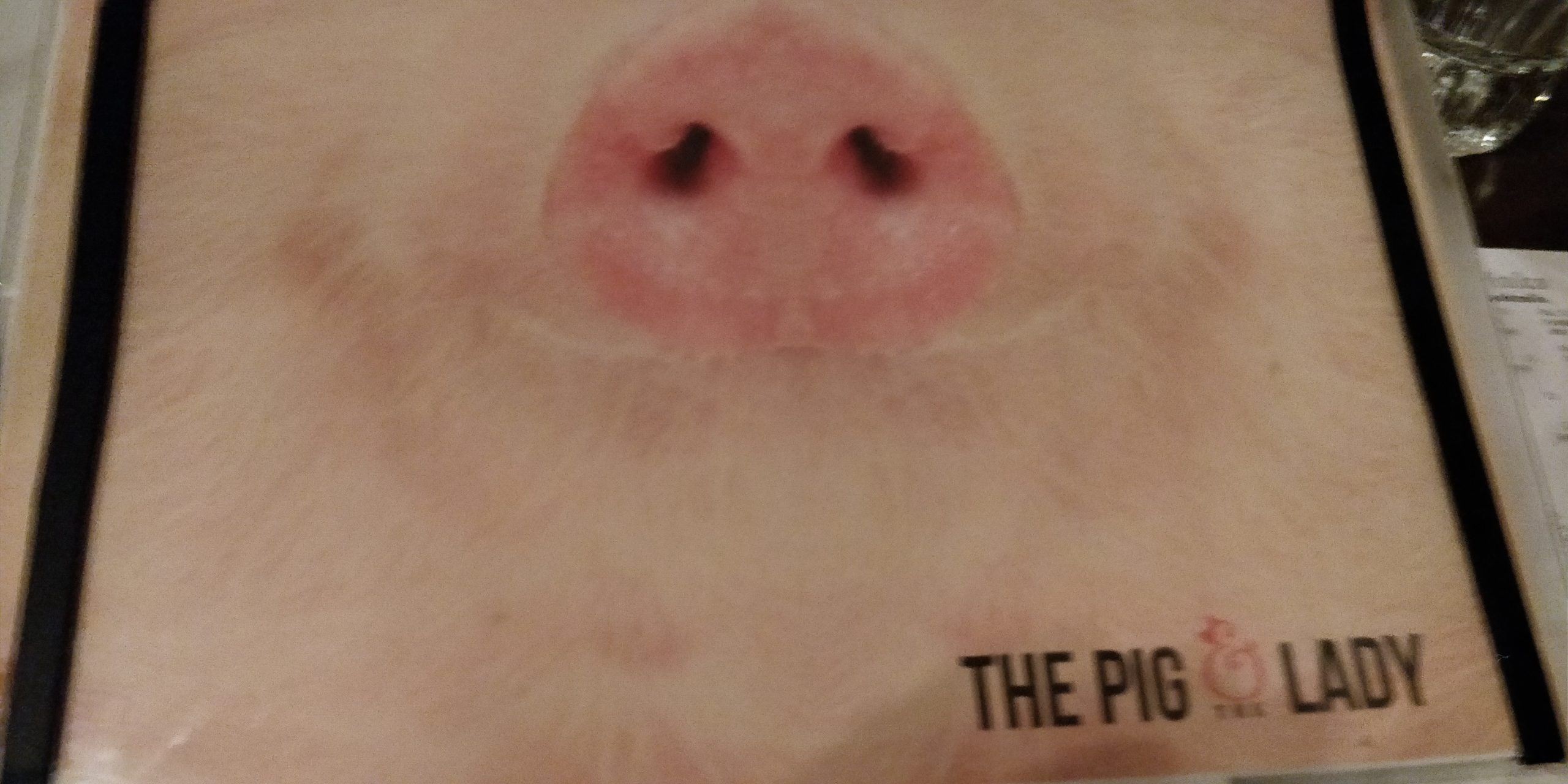 PICTURE OF THE MENU COVER SHOWING A PIG'S SNOUT