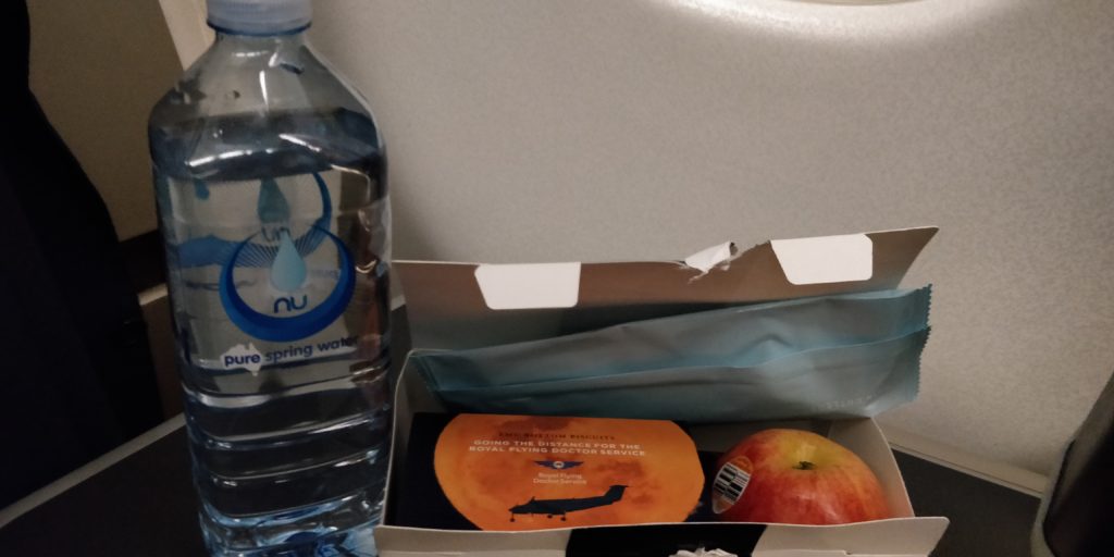 picture of the box lunch and bottle of water served in business class. Very sad. No drinks. No hot service while flying the coop.