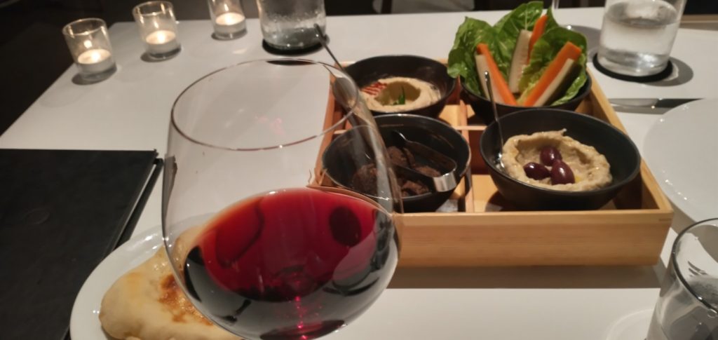 picture of the bento box, wine, and pita bread