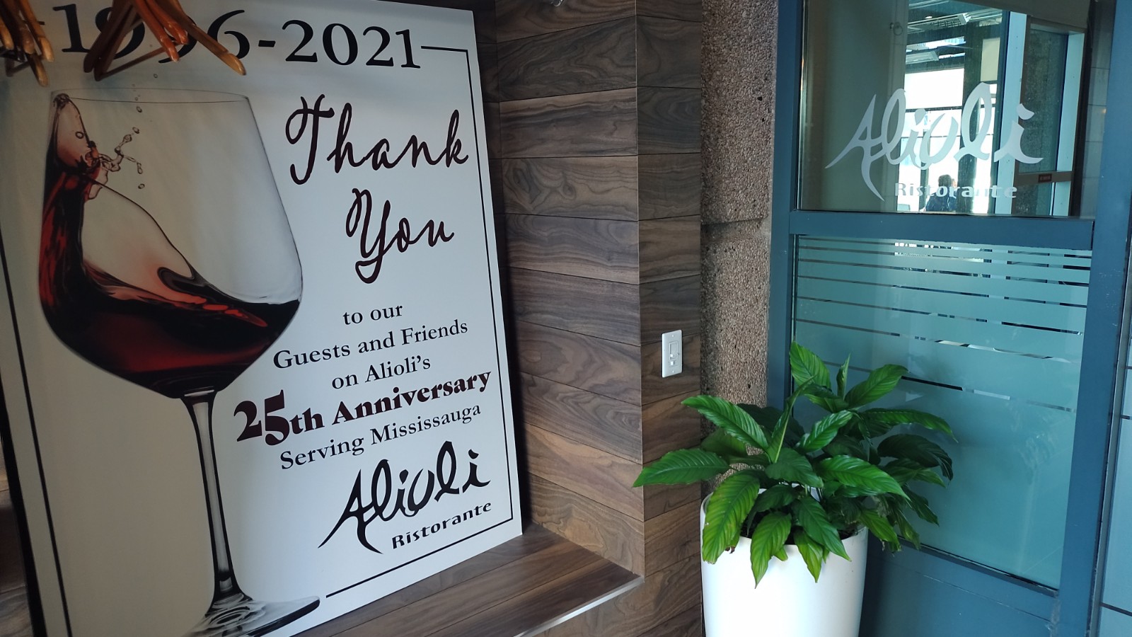 A picture of a sign at the entrance marking the restaurant's 25th anniversary.