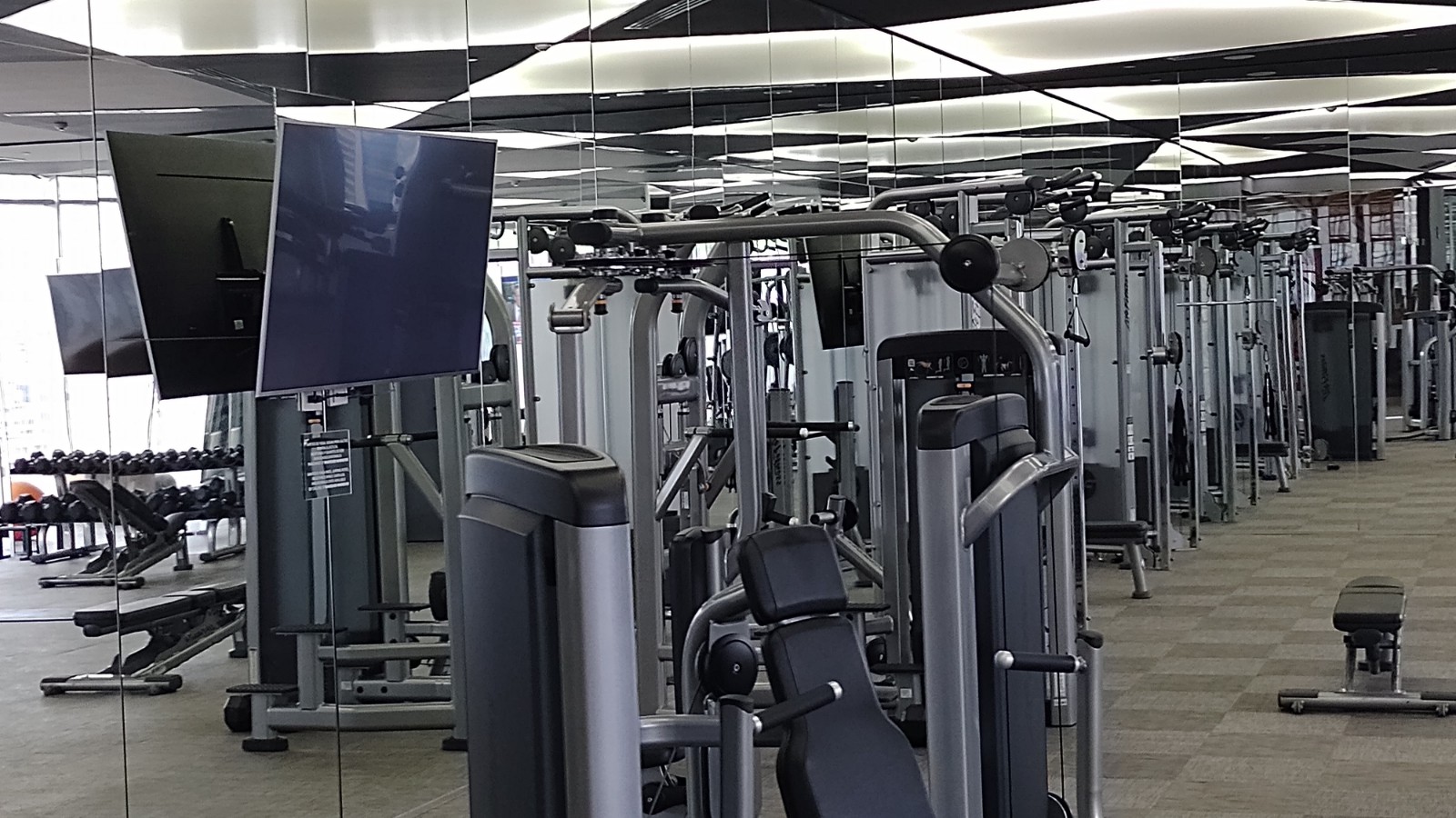 PICTURE OF THE WEIGHT ROOM AND WORKOUT MACHINES.