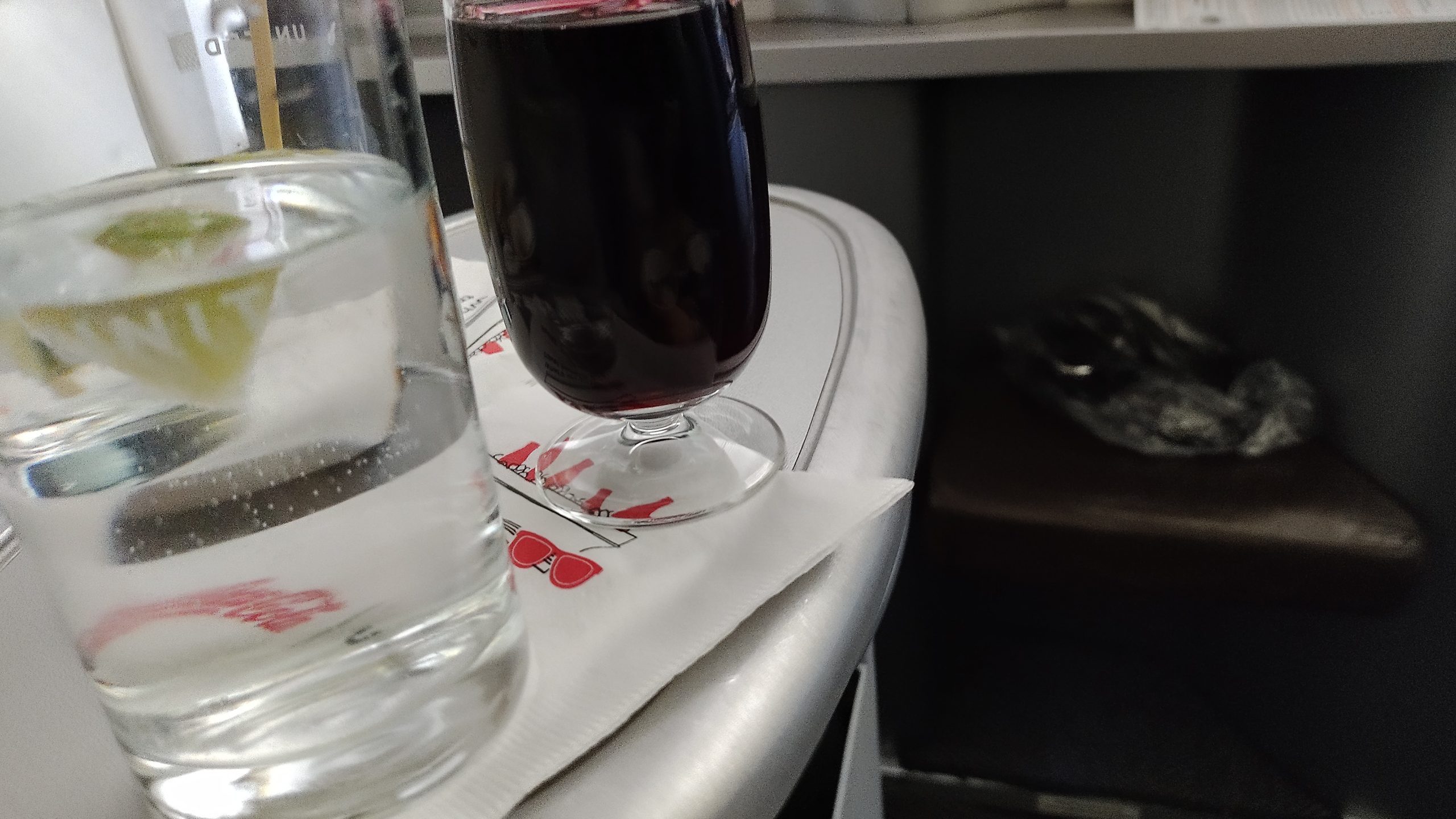 picture of a glass of wine and the glass of water served on the flight