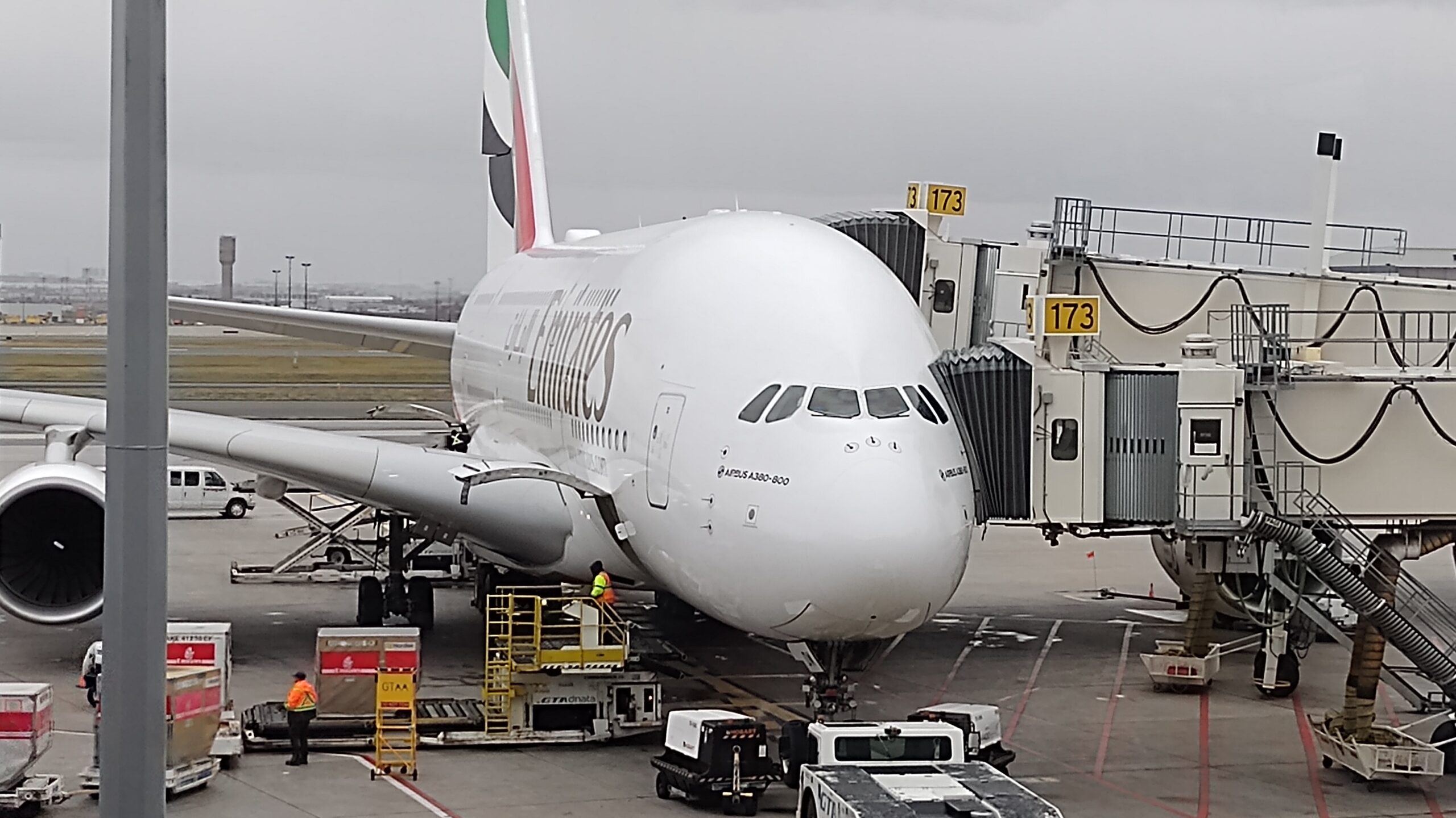 picture of Emirates 380-800 parked at the gate of Toronto's Pearson Airport.