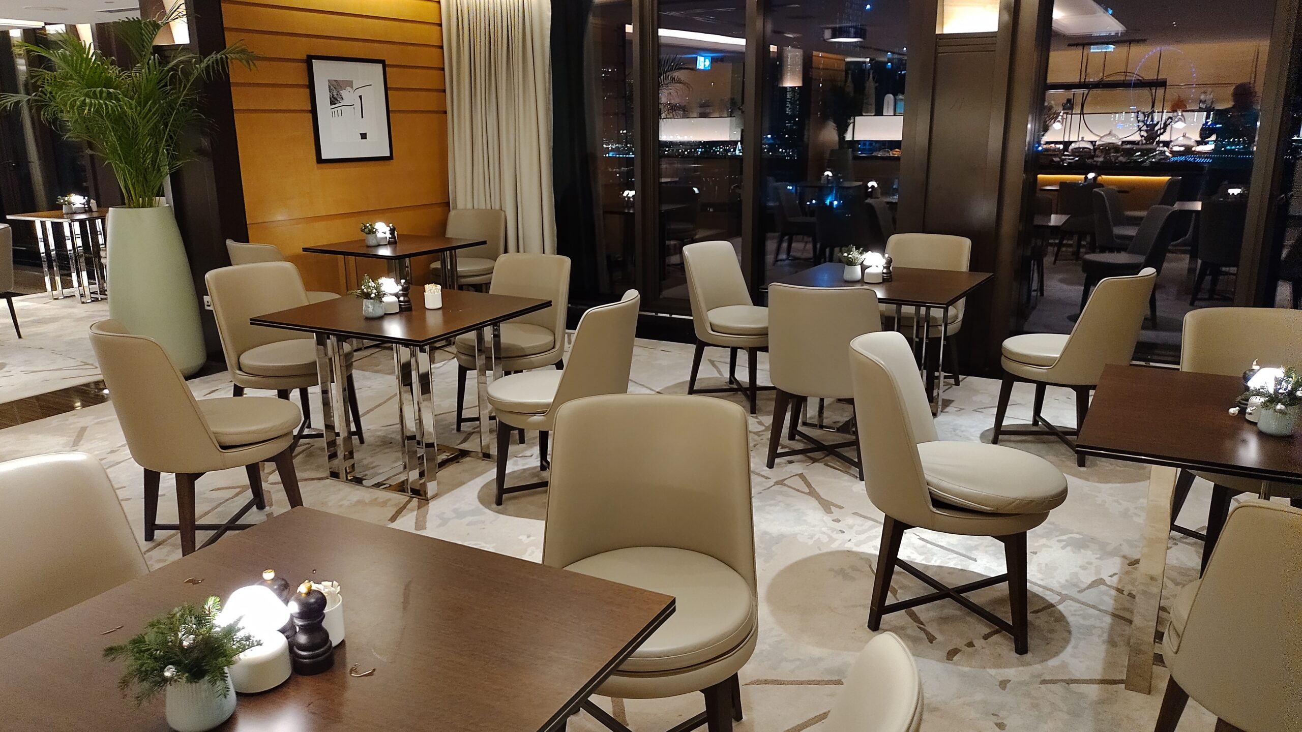 A PICTURE OF SOME OF THE SEATING  IN THE M CLUB EXECUTIVE LOUNGE.