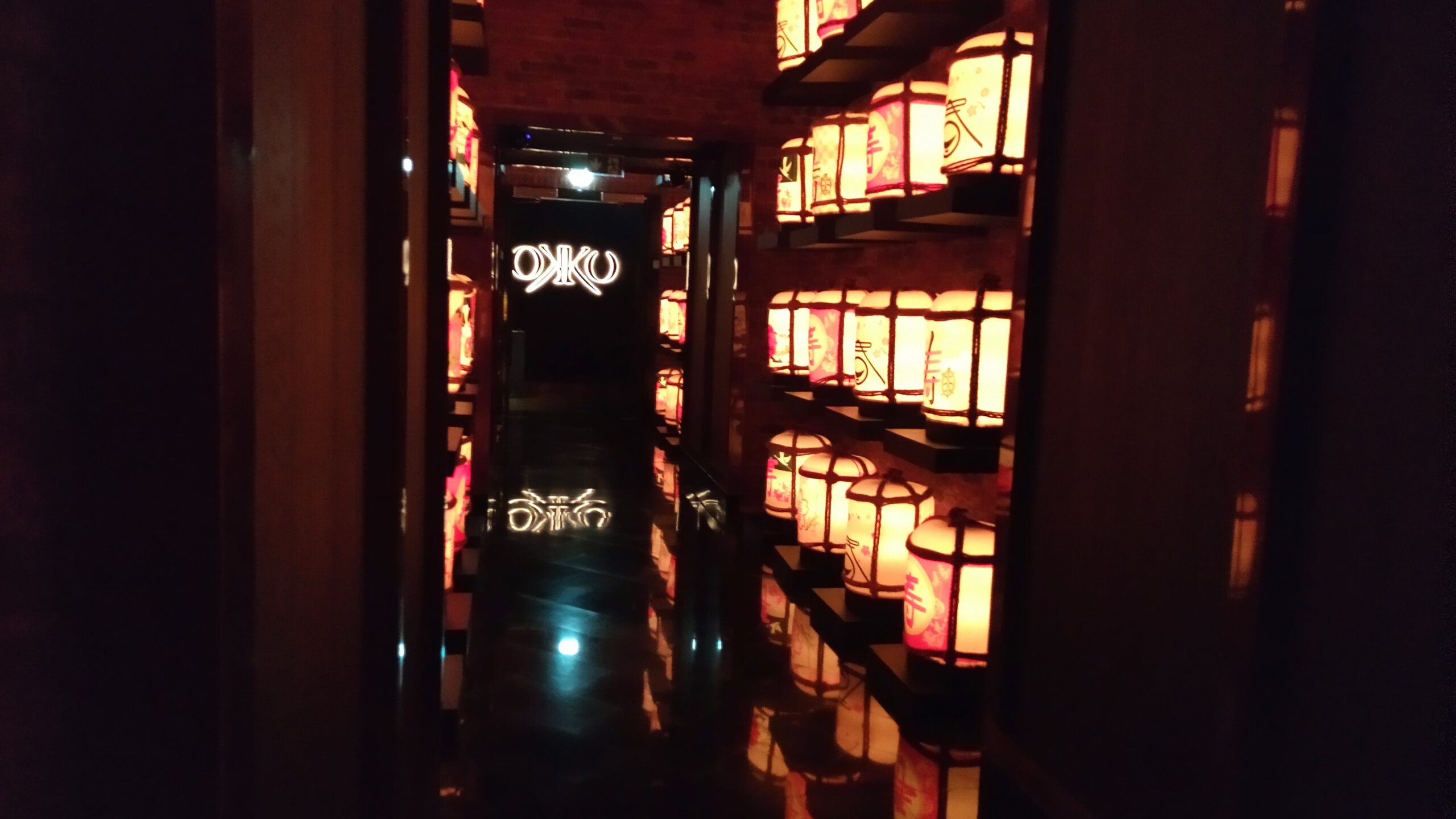 PICTURE OF THE LIGHTED SAKE BARRELS HALLWAY LEADING TO THE MAIN DINING ROOM.