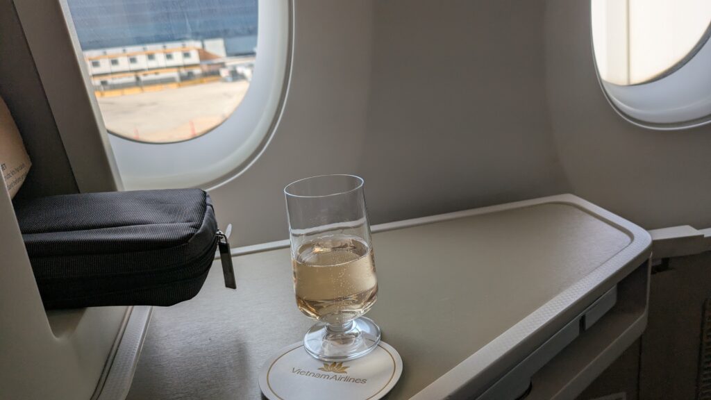 PICTURE OF A GLASS OF CHAMPAGNE RESTING ON MY ARMREST.