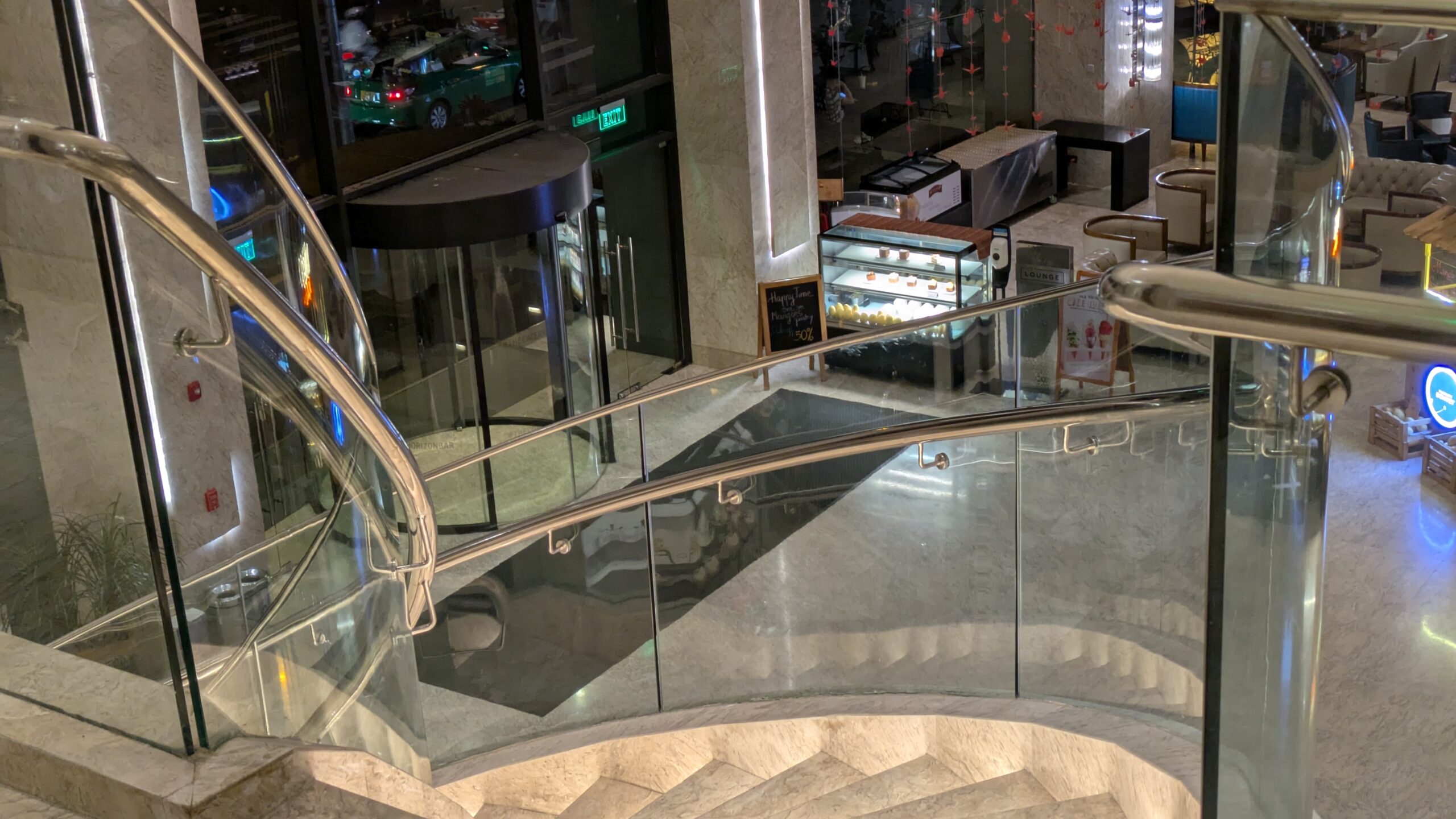 PICTURE OF THE SPIRAL STAIRCASE FROM THE SECOND FLOOR LOOKING DOWN ON THE LOBBY.